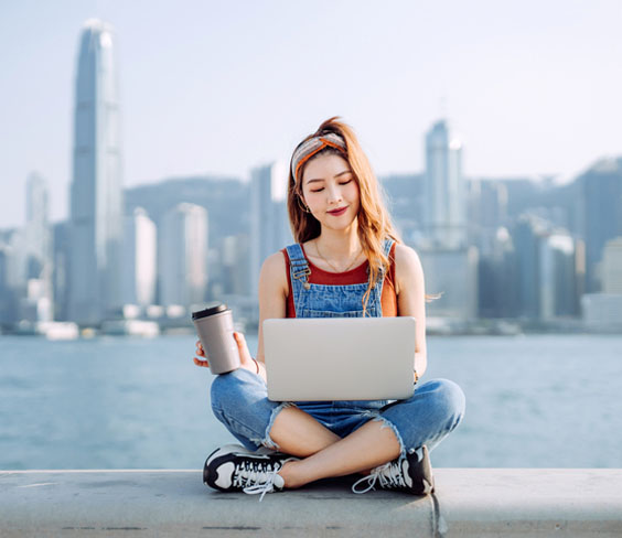 Gen Z Asian woman browsing ecommerce websites and shopping on her laptop
